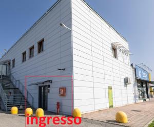a white building with a fire hydrant in front of it at Foresteria SMART ROOMS in Viadana