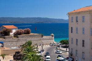 a view of a street in a town next to the ocean at Hotel San Carlu Citadelle Ajaccio in Ajaccio
