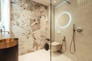 a bathroom with a toilet and a glass shower at Sael Privè in Golem +167 photos