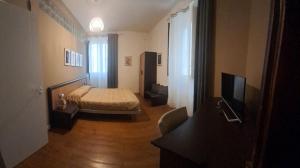a bedroom with a bed and a television in it at Casa Antioco B&B in Syracuse