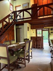 a dining room with a wooden table and chairs at Rincón del Cielo Country Club in Merlo