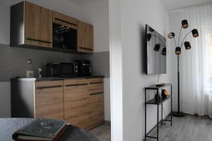 a kitchen with a sink and a microwave and a counter at Auszeit in Bad Dürkheim