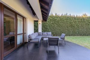 a patio with a couch and chairs and a table at The One Wadowice in Wadowice