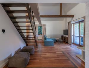 a living room with a staircase and a couch at The One Wadowice in Wadowice