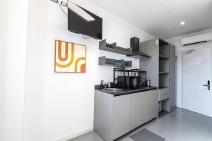a kitchen with white cabinets and a sink at Foresteria SMART ROOMS in Viadana