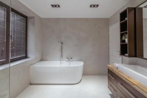a white bathroom with a tub and a sink at The One Wadowice in Wadowice +34 photos