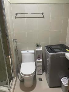 a small bathroom with a toilet and a sink at Casa MJ Suites at SMDC Fame Residences, Mandaluyong in Manila +12 photos