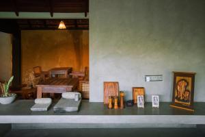 a counter with pictures and chairs on it with a table at The Yala Lodge in Kirinda