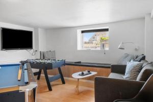 a living room with a ping pong table in it at 705-Thyboron-Romovej-7 in Thyborøn