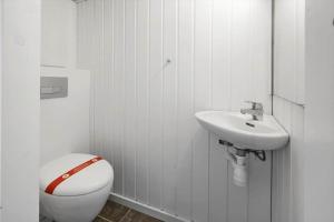 a white bathroom with a toilet and a sink at 705-Thyboron-Romovej-7 in Thyborøn +22 photos