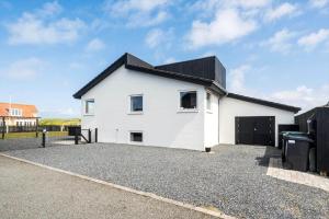 a white house with a black roof at 705-Thyboron-Romovej-7 in Thyborøn