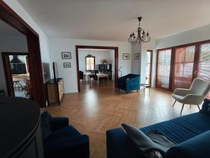 a living room with a blue couch and a table at Villa Terra in Nałęczów