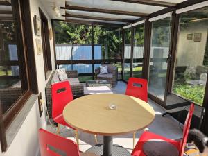 a patio with a table and red chairs at Ferienhaus-Maxen in Müglitztal