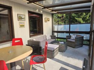 a patio with a couch and a table and chairs at Ferienhaus-Maxen in Müglitztal