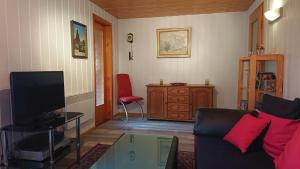 a living room with a couch and a glass table at Ferienhaus-Maxen in Müglitztal +9 photos