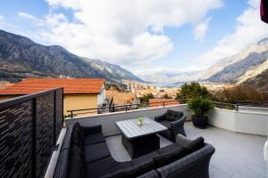 a patio with a table and chairs on a balcony at Villa Azure Luxe in Škaljari