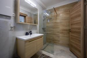 a bathroom with a sink and a shower at Villa Azure Luxe in Škaljari +54 photos