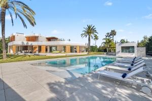a villa with a swimming pool and a house at Casa Torus Luxury Design Villa with Private SPA & Cinema in Jávea