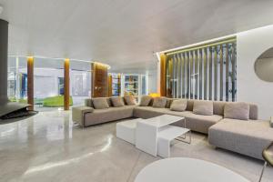 a living room with a couch and a table at Casa Torus Luxury Design Villa with Private SPA & Cinema in Jávea