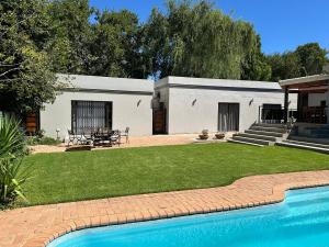 a house with a swimming pool in a yard at Divine2 Elegant Luxury suite in Bloemfontein