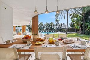 a dining room with a table with food on it at Casa Torus Luxury Design Villa with Private SPA & Cinema in Jávea