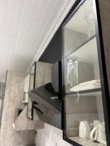 a glass cabinet in a kitchen with a staircase at Divine2 Elegant Luxury suite in Bloemfontein +9 photos