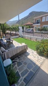 a patio with a couch and a table in a yard at MariGold Villa in Prinos