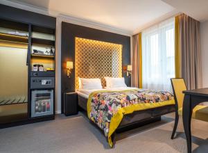 a bedroom with a bed and a table and a desk at Thon Hotel Rosenkrantz Oslo in Oslo +62 photos