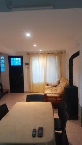 a bedroom with a bed and a room with a fireplace at Duplex en Valle Hermoso in Valle Hermoso