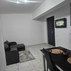 a living room with a couch and a table at New studio in Râmnicu Vâlcea