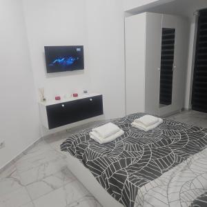 a bedroom with a bed with two pillows on it at New studio in Râmnicu Vâlcea
