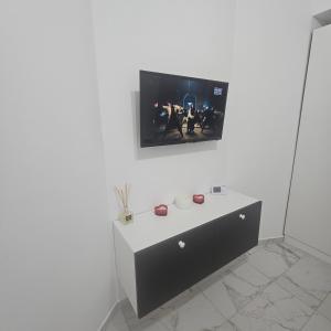 a white room with a tv on a white wall at New studio in Râmnicu Vâlcea +3 photos
