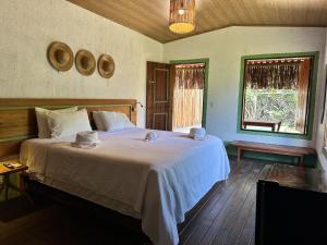 a bedroom with a large bed in a room at Pousada Rancho Luar in Pôrto de Pedras +138 photos