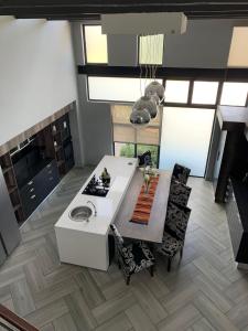 a kitchen with a stove and a table and chairs at Sunset View Vaal De Grace in Grooteiland