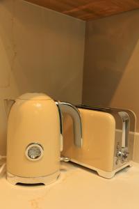 a toaster sitting on top of a counter at Heathrow Royal Apartment in Ashford