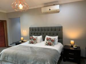 a bedroom with a large bed with two tables and two lamps at Sunset View Vaal De Grace in Grooteiland +24 photos