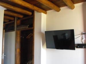 a flat screen tv hanging on a wall at Cantalao in Santa Clara del Mar