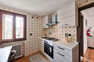 a kitchen with a stove top oven next to a window at Villa jolly mini appartament in Marghera