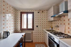a kitchen with a sink and a stove top oven at Villa jolly mini appartament in Marghera +7 photos
