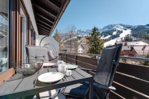 a table and chairs on a balcony with a view at Bergnest Iseler mit Panoramablick in Oberjoch