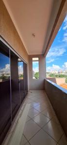 a large empty room with a large window in a building at SOBRADO - ótimo custo beneficio - 3 quartos com ar in Campo Grande
