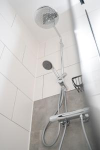 a shower with a shower head in a bathroom at Bergnest Iseler mit Panoramablick in Oberjoch +12 photos