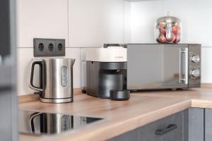 a kitchen counter with a coffee maker and a microwave at Bergnest Iseler mit Panoramablick in Oberjoch