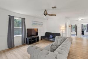 a living room with a couch and a tv at The Flying Dutchman OBX in Kill Devil Hills