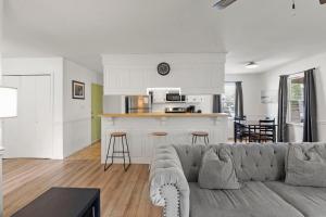 a living room with a couch and a kitchen at The Flying Dutchman OBX in Kill Devil Hills