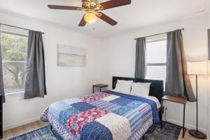 a bedroom with a bed and a ceiling fan at The Flying Dutchman OBX in Kill Devil Hills