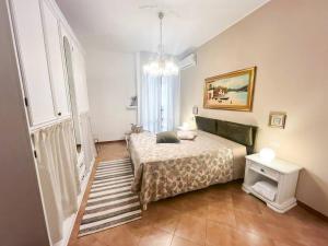 a bedroom with a bed and a chandelier at CasaLina Perfect House in Altamura +19 photos