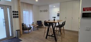 a room with a table and chairs in a building at Cais 75 Studios & Suites in Aveiro