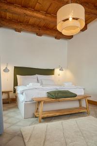 a bedroom with a large bed and a table at TR 1823 Vendégház in Mád