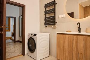 a washing machine in a kitchen with a sink at TR 1823 Vendégház in Mád